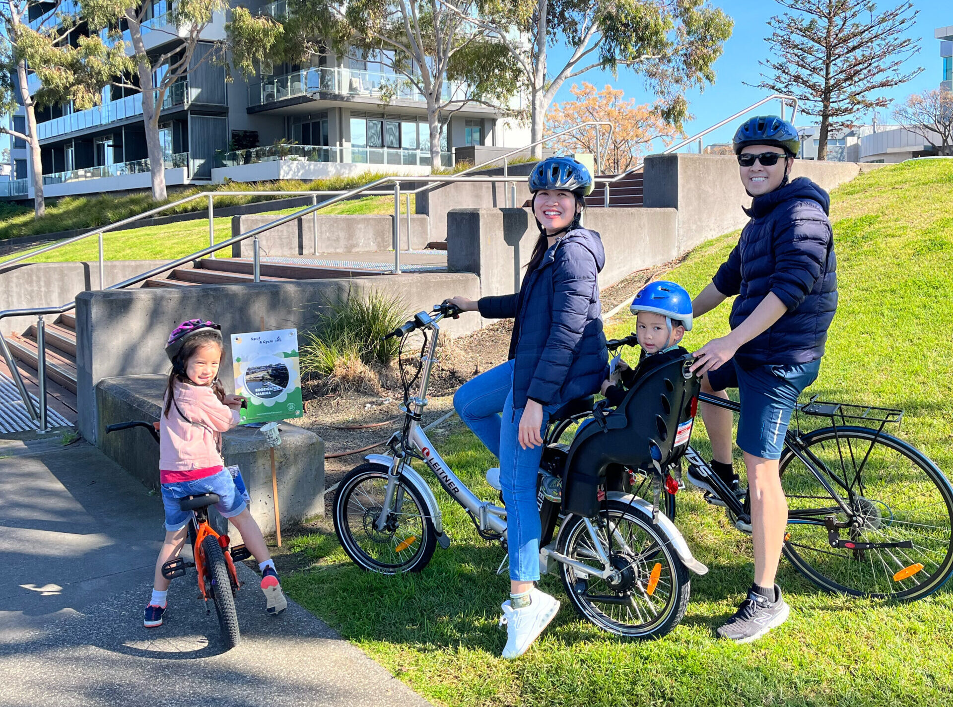 Family on bicycles in park