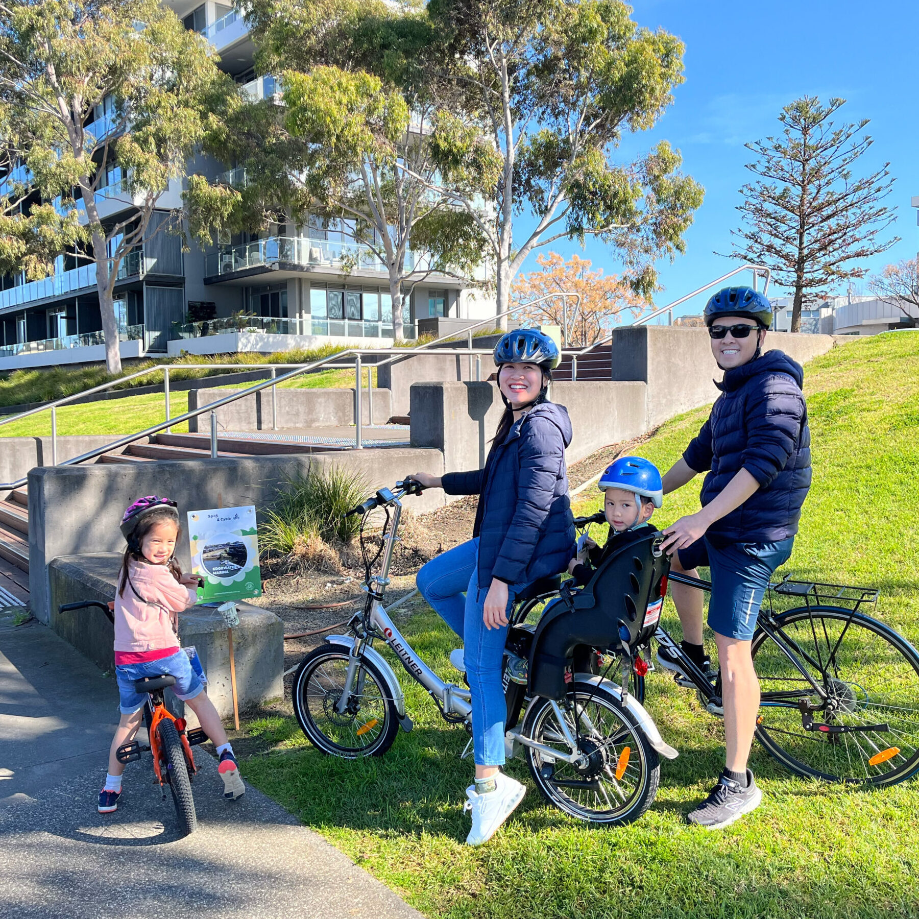 Family on bicycles in park